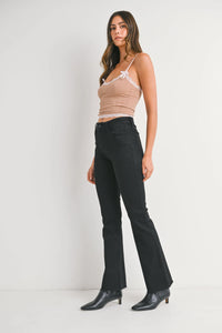 Women’s light brown camisole with white lace trim and black mid rise flare denim jeans