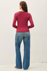 Women’s magenta scoop neck long sleeve top with wide-leg blue jeans, stylish casual wear