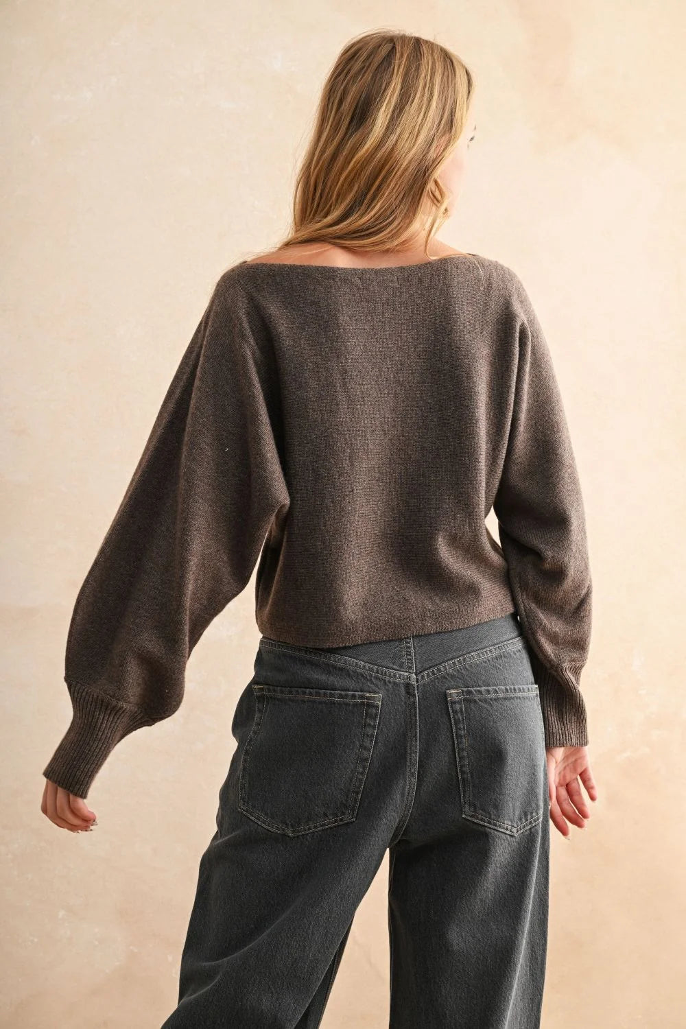 Women’s long-sleeved dark brown boat neck sweater showcasing a stylish boat neck design