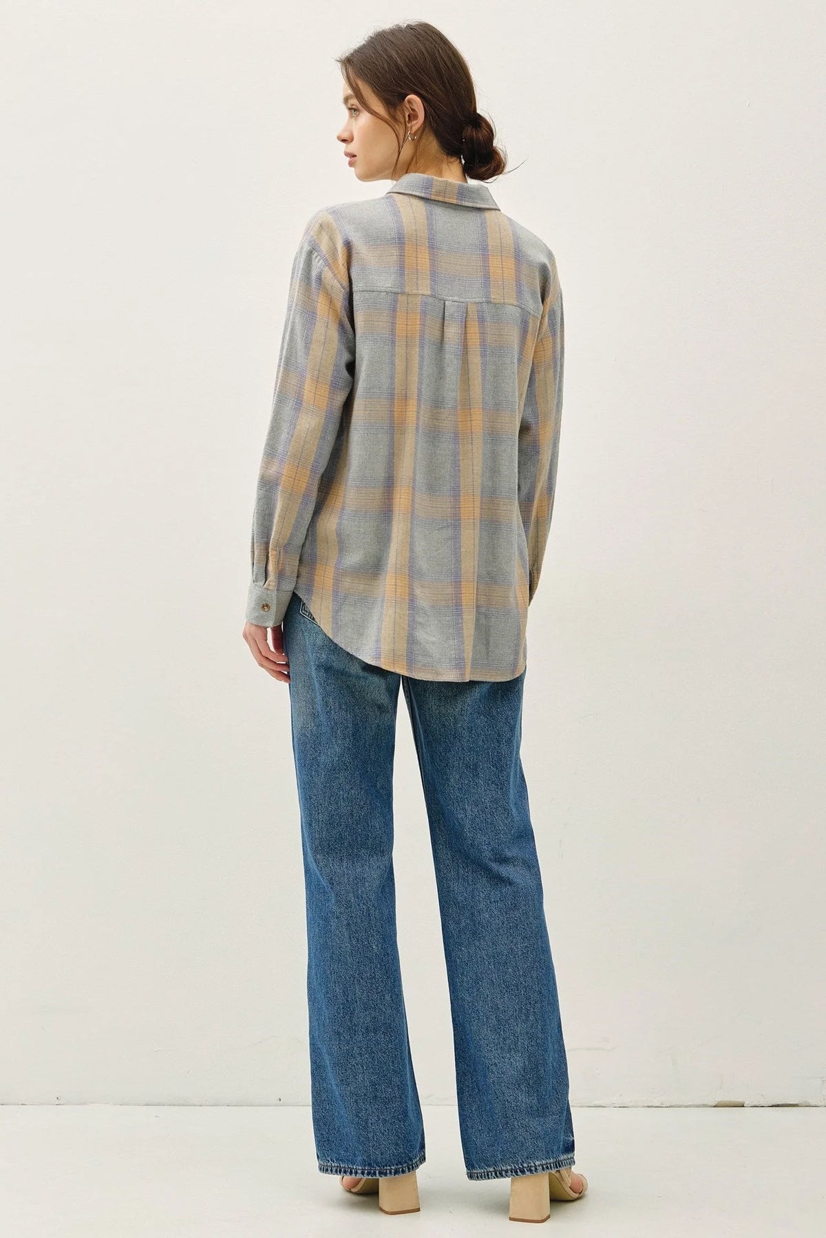 Women’s classic cotton faded plaid shirt with blue and orange checks, paired with jeans
