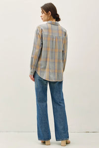 Women’s classic cotton faded plaid shirt with blue and orange checks, paired with jeans