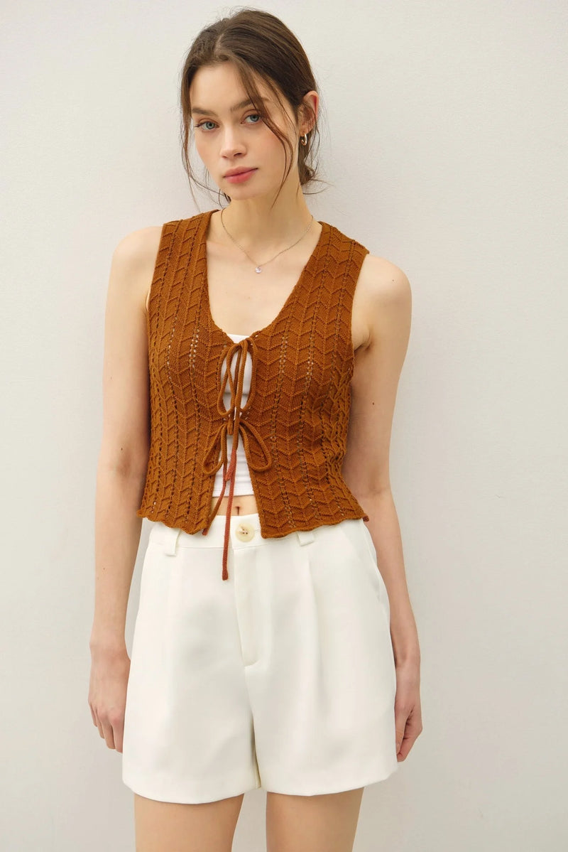 Women’s open-knit rust-colored vest with tie fastening and wavy knit design