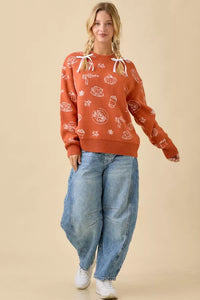 Women’s oversized orange pumpkin spice printed sweater with white pumpkin and coffee graphics