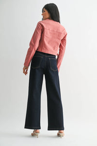 Women’s pink cropped denim jacket with patch pockets paired with dark wash wide-leg denim jeans