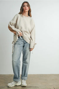 Women’s beige crew neck long sleeve pullover sweater with lace-up sleeve and side details