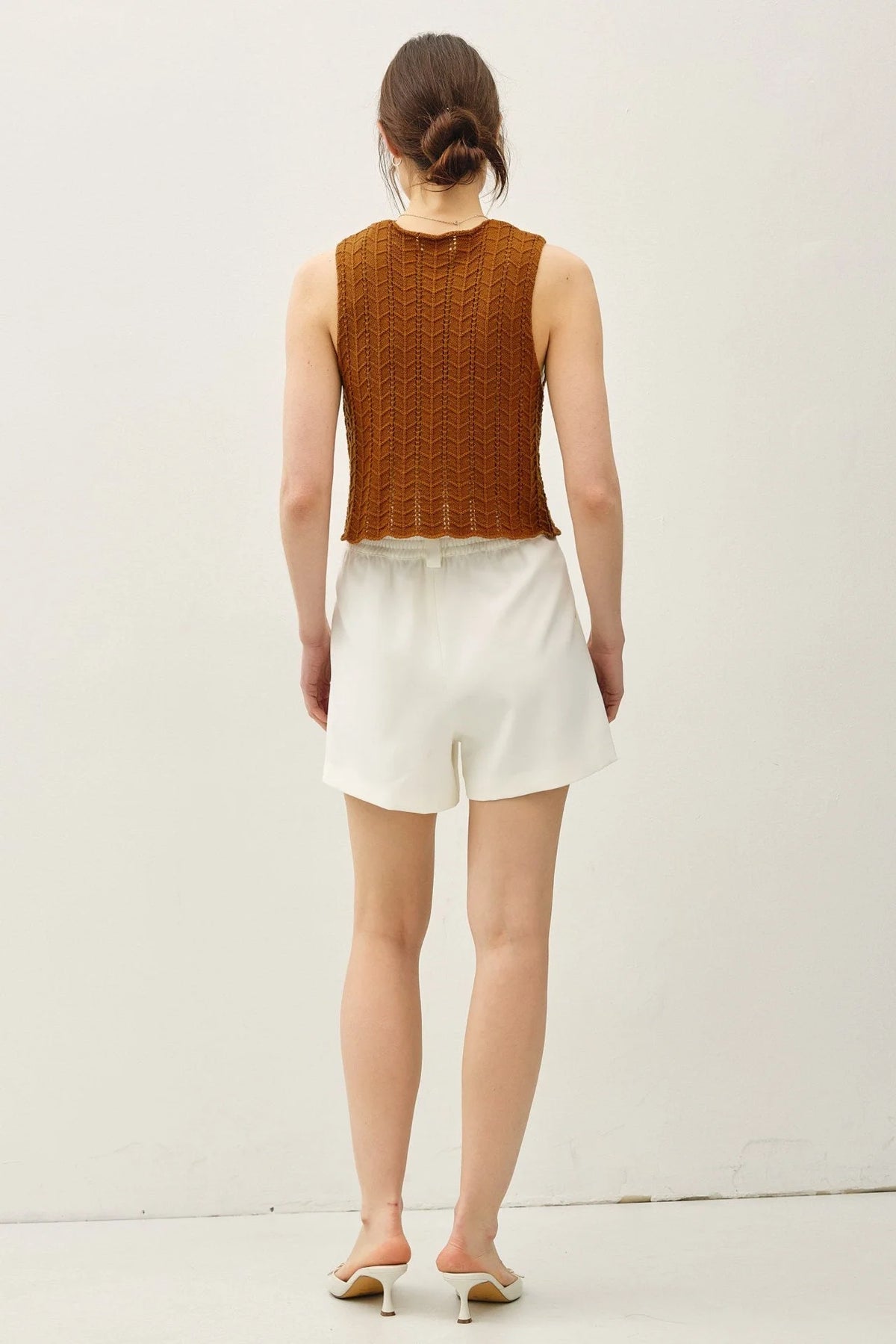 Wavy knit tie fastening vest with sleeveless brown knit top and white shorts for women