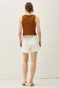Wavy knit tie fastening vest with sleeveless brown knit top and white shorts for women