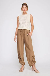 Women’s sleeveless knit top with crew neck and open-knit pattern paired with Adjustable Scrunch Jogger