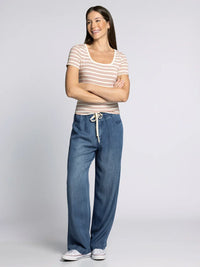 Women’s striped short-sleeve top with wide-leg denim pants featuring the Supply Katara Tee style