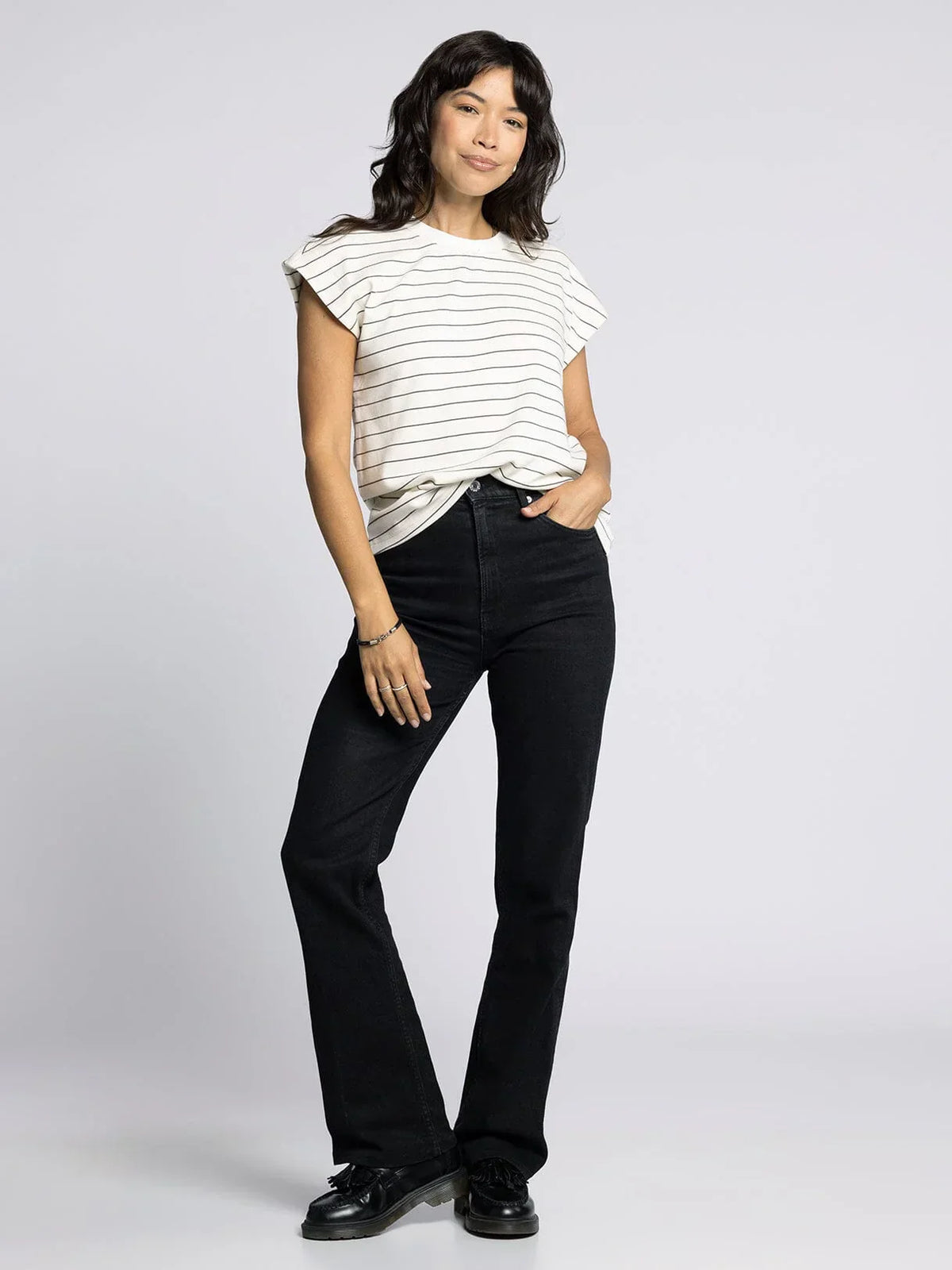 Women’s striped short-sleeve bella tee paired with black flare jeans for a casual look