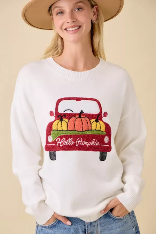 Women’s white crewneck sweater with pumpkin truck embroidered patchwork design