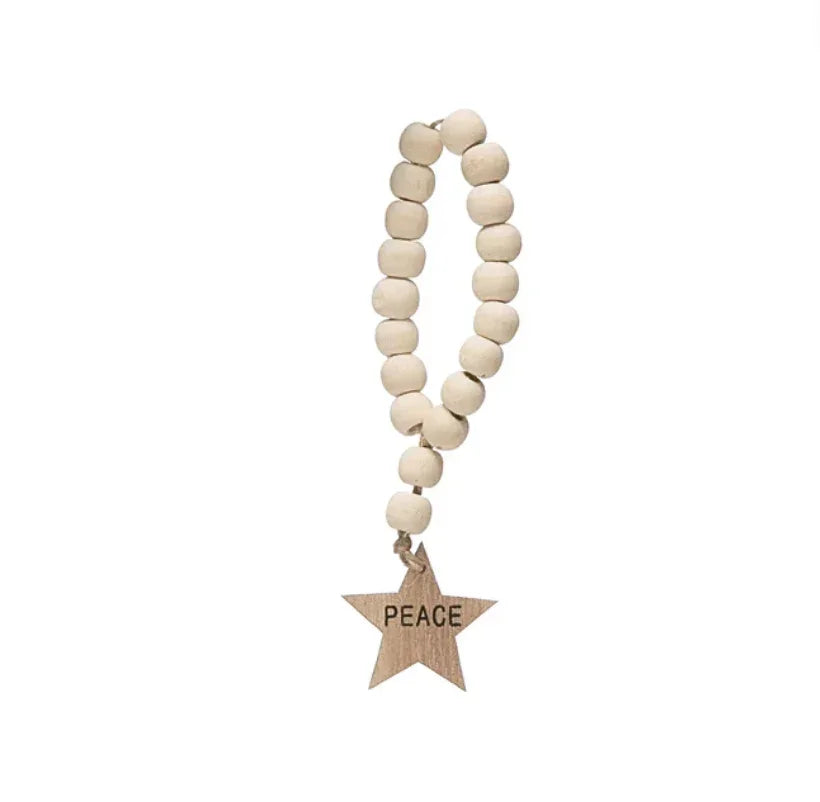 Wooden bead garland with star-shaped PEACE charm for women’s boho chic clothing at Shop Daisy