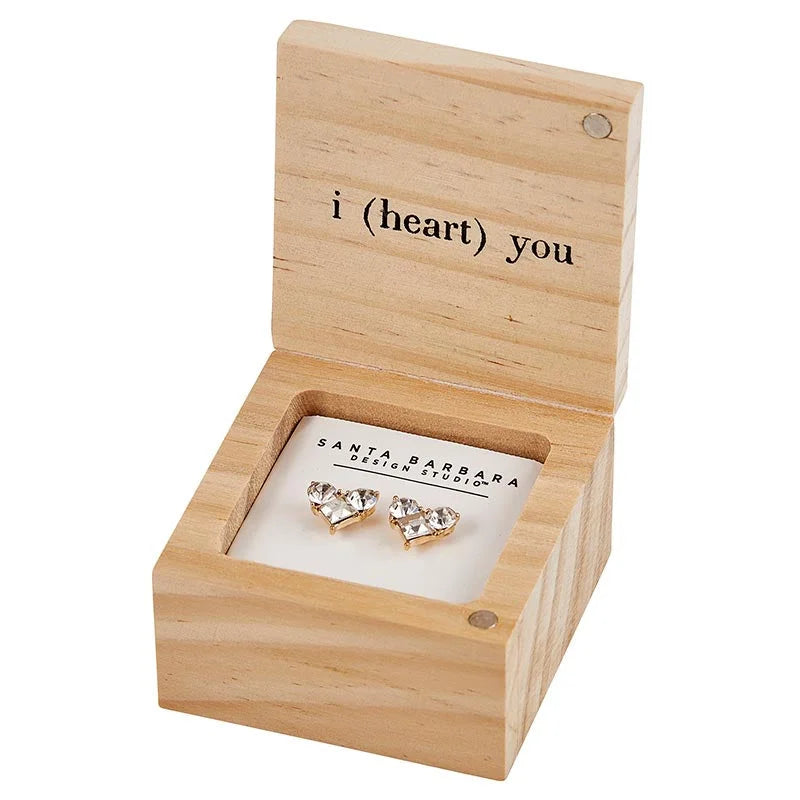 Wooden treasure box containing heart-shaped earrings with I heart you engraving