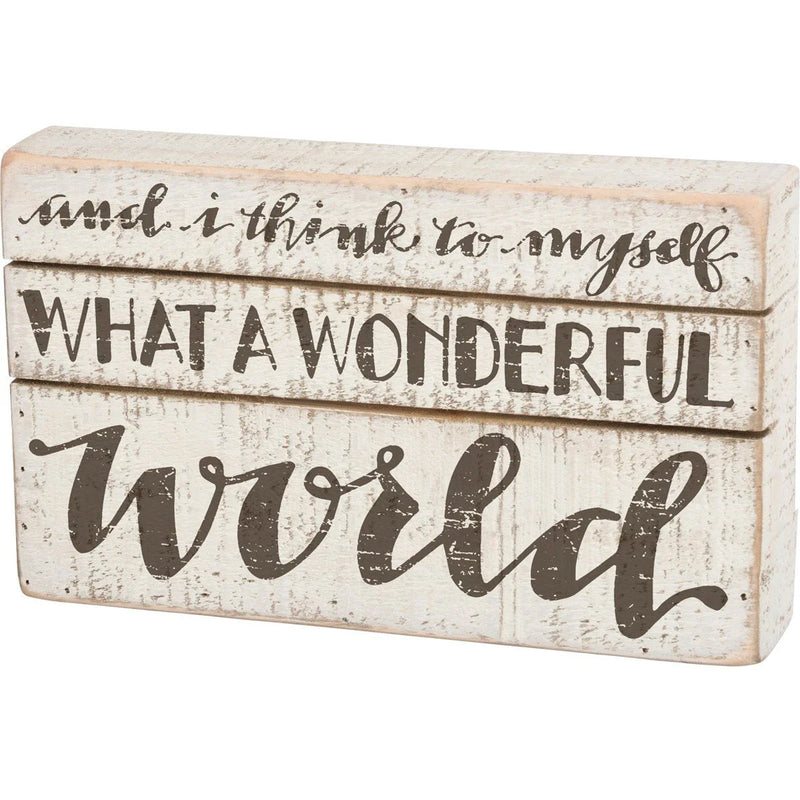 Wooden box wall decor featuring the phrase Be Kind of What a Wonderful World