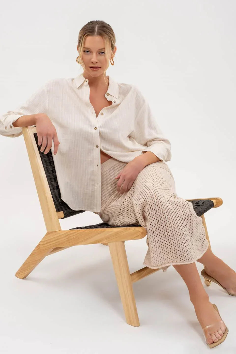 Wooden chair with minimalist design complements STRIPE COLLARED BUTTON DOWN SHIRT style