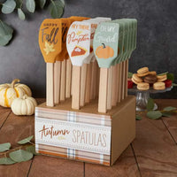 Wooden display stand with decorative autumn baking silicone spatulas featuring pumpkin designs