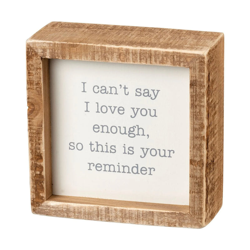 Wooden frame showcasing a heartfelt quote in a boho I CAN’T SAY I LOVE YOU ENOUGH box sign