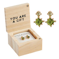 Wooden jewelry box with green gemstone earrings and YOU ARE A GIFT text for women’s boho chic clothing