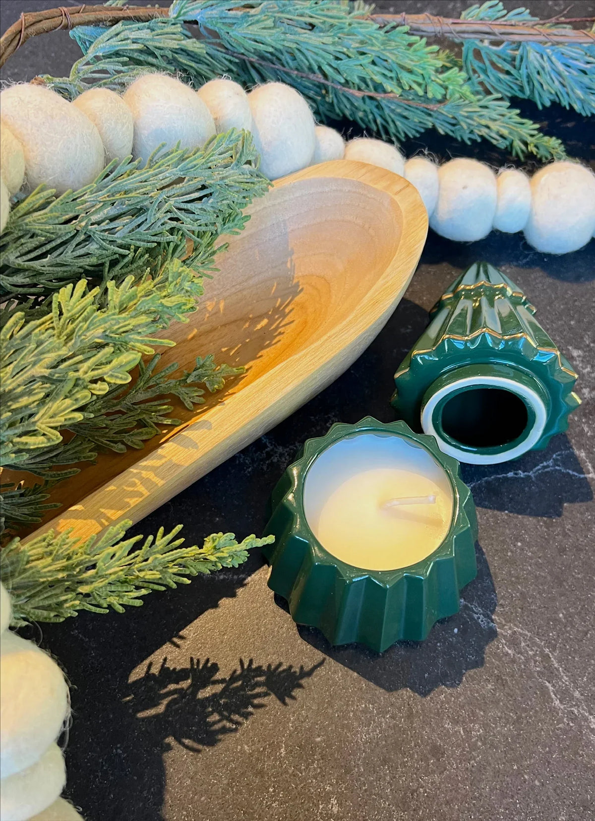 Wooden spoon with a golden bowl beside Juniper Spice Gilded Tree Ceramic Candle