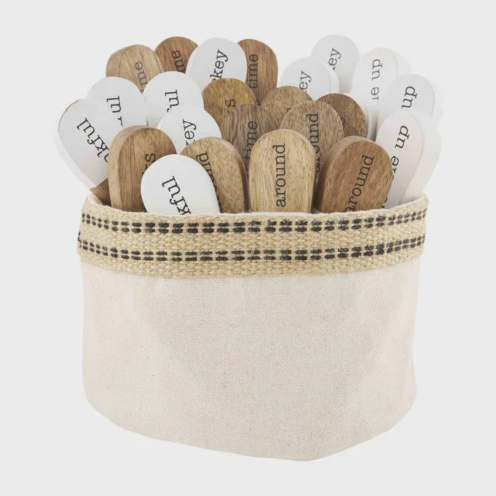 Wooden thankfulness spreaders with white labels in a fabric container, handcrafted mango wood