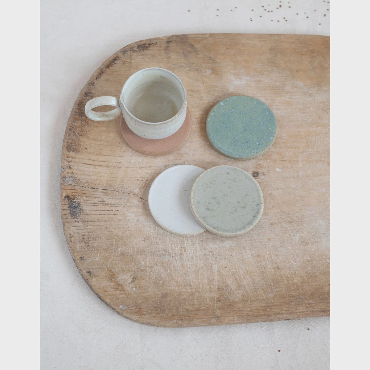 Wooden tray displaying a Stoneware Mug with Reactive Glaze and matching saucer