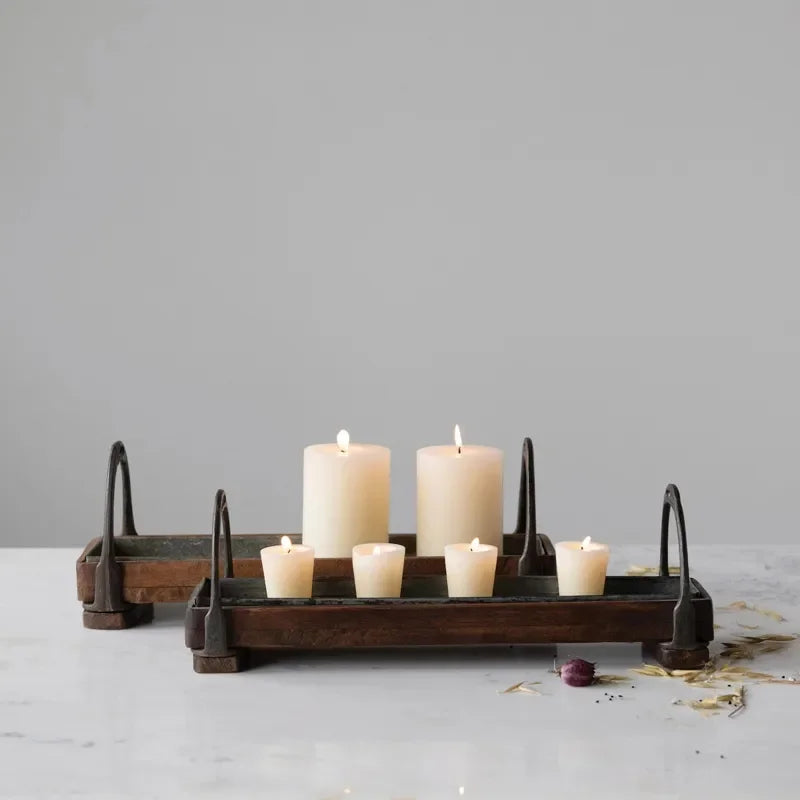 Wood and metal tray holding lit candles, perfect for rustic bohemian decor