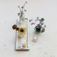 Wood tray embossed with two glasses and flowers, highlighting embossed glass tealight holders