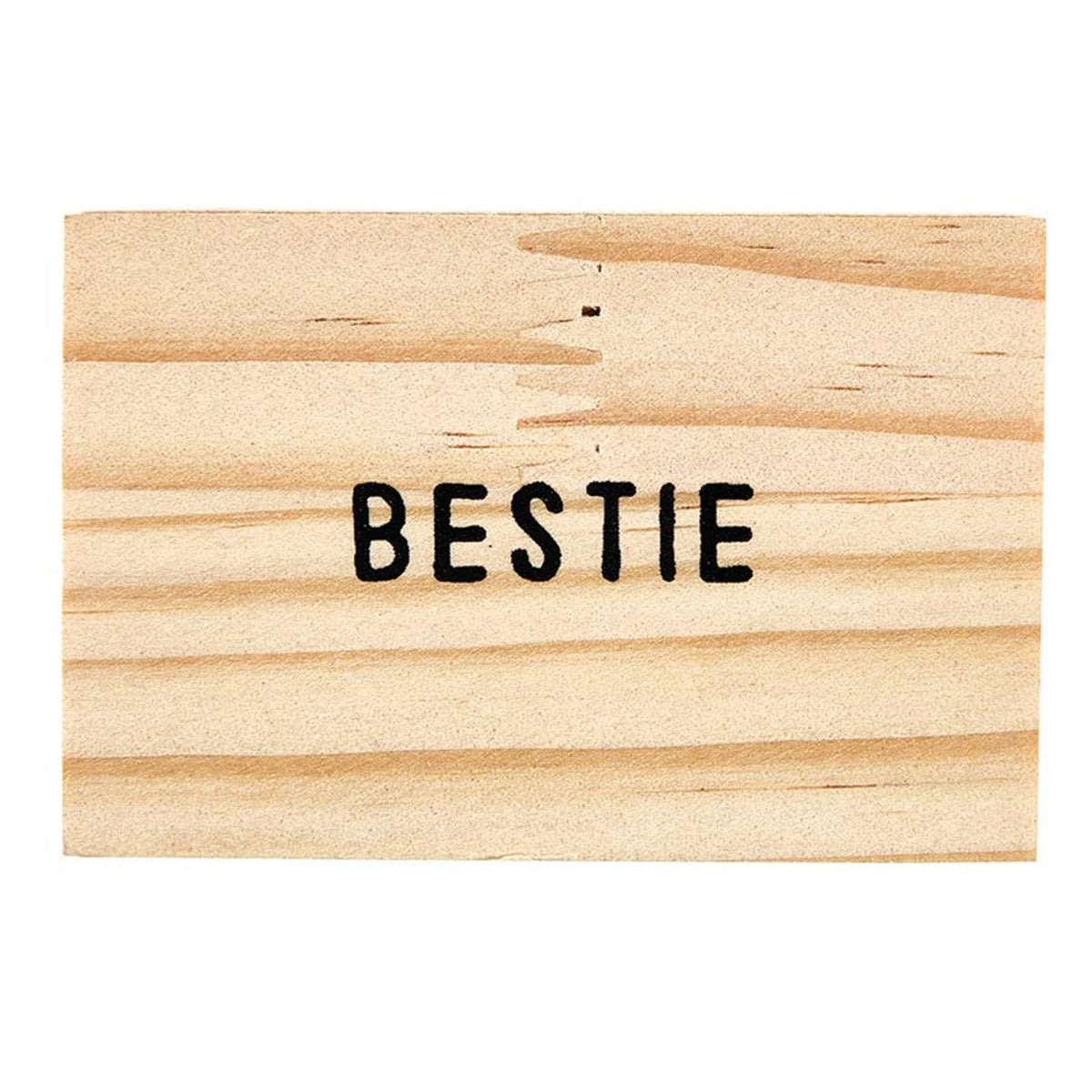 Bestie stamped on light wood for the Gold Chain Bestie Necklace at Shop Daisy