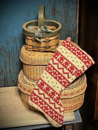 Woven baskets with a knitted red mini Christmas stocking on a Christmas stockings holder