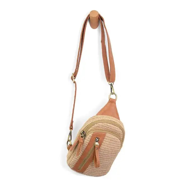 Woven crossbody bag with leather accents showcased in the STRAW SKYLER SLING BAG product image