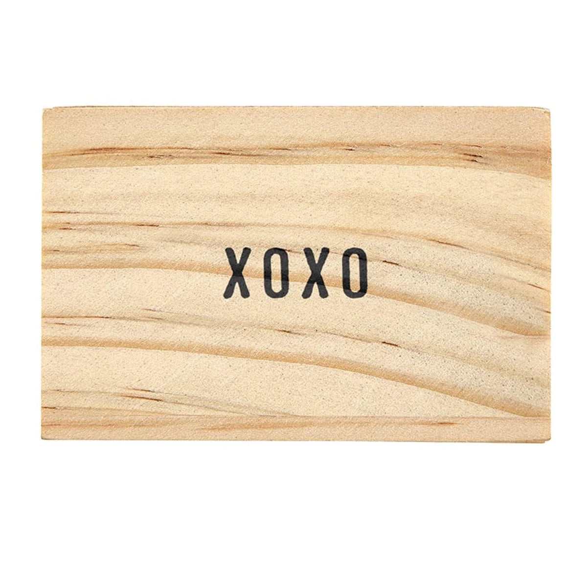 XOXO text on a light wooden surface for the Gold Chain XOXO Necklace by Shop Daisy