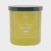 Yellow California Dreaming Candle with black lid and white label displayed elegantly