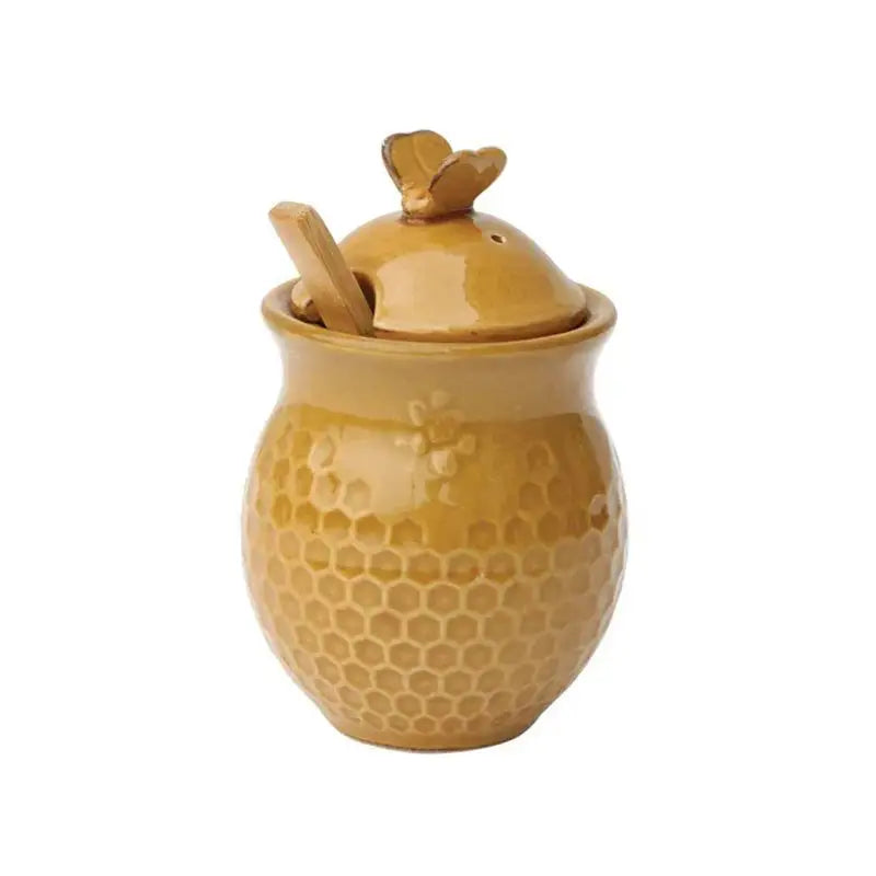 Yellow ceramic honey jar with honeycomb pattern and bee-shaped lid handle