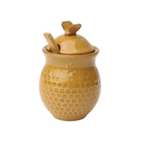 Yellow ceramic honey jar with honeycomb pattern and bee-shaped lid handle