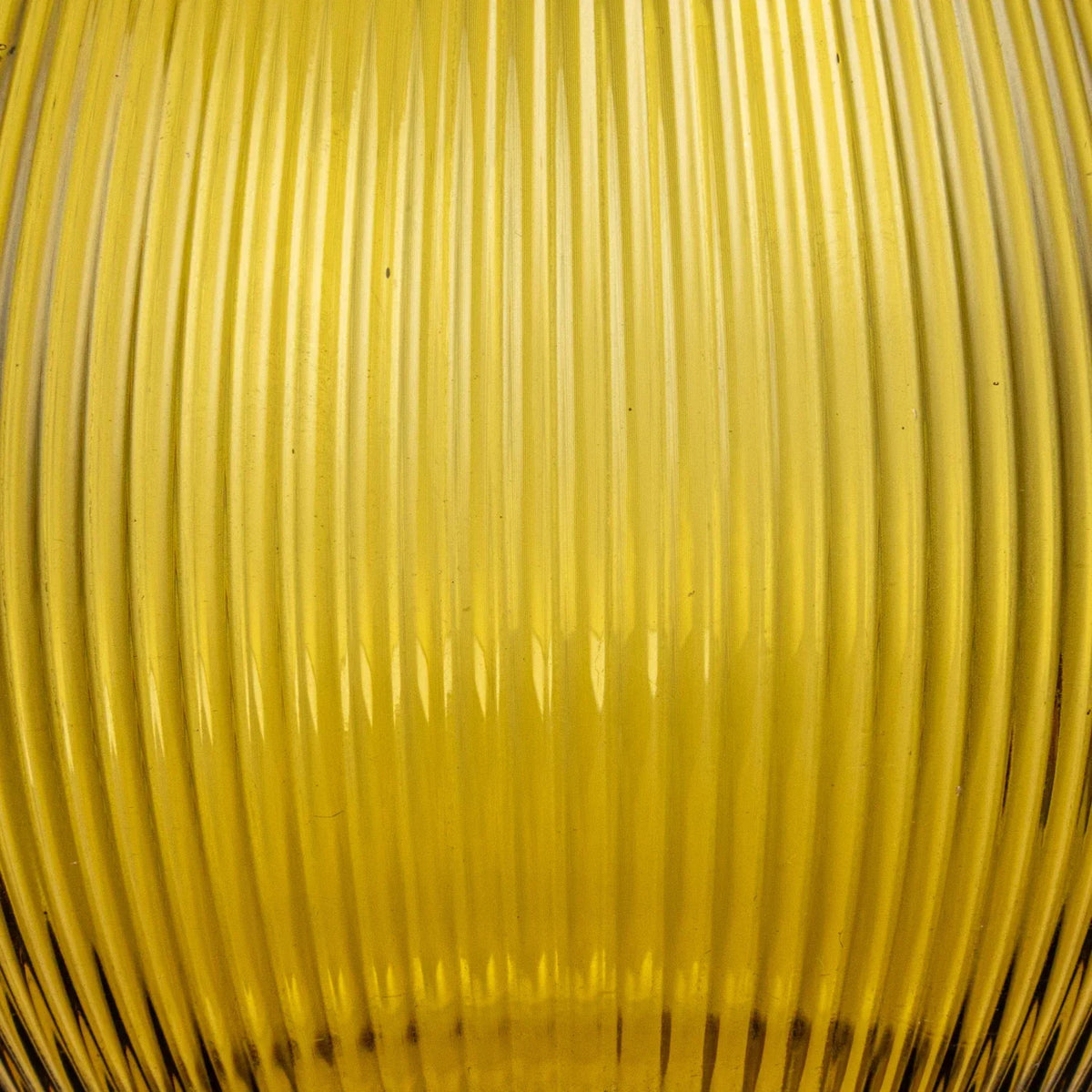 Yellow glass vase with a thin rim beside a 2-1/2 quart fluted glass pitcher