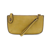 Yellow leather wristlet clutch featuring card slots from the MINI CROSSBODY WRISTLET CLUTCH