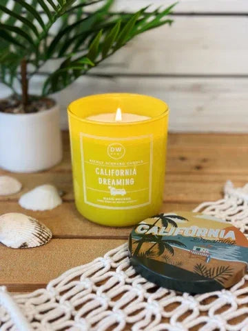 Yellow scented candle in glass labeled California Dreaming for a boho free spirit vibe