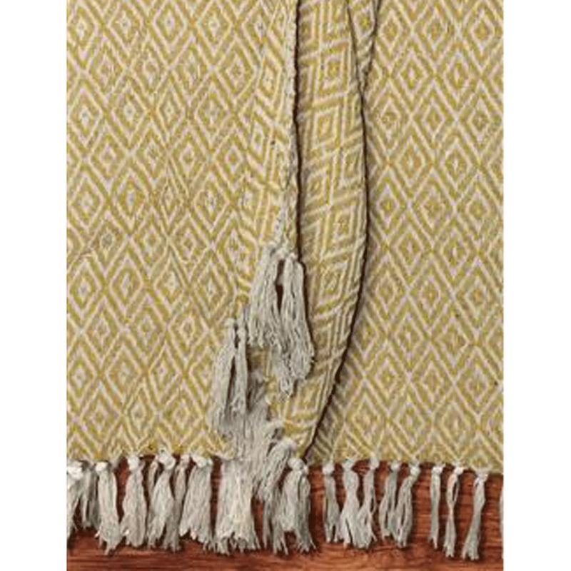 Woven Yellow and Ecru Cotton Throw with Fringes proudly displayed on a surface