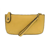 Yellow wristlet clutch with card slots, available at Shop Daisy for women’s boho chic clothing