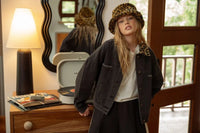 Young woman wearing leopard collar black denim jacket with black denim and leopard print bucket hat