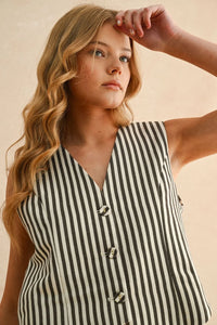 Young woman wearing a striped button front vest, perfect for women’s boho chic clothing at Shop Daisy