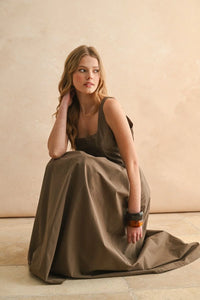 Young woman in olive-green boho chic dress with bracelets, ideal for women’s boho clothes from Shop Daisy