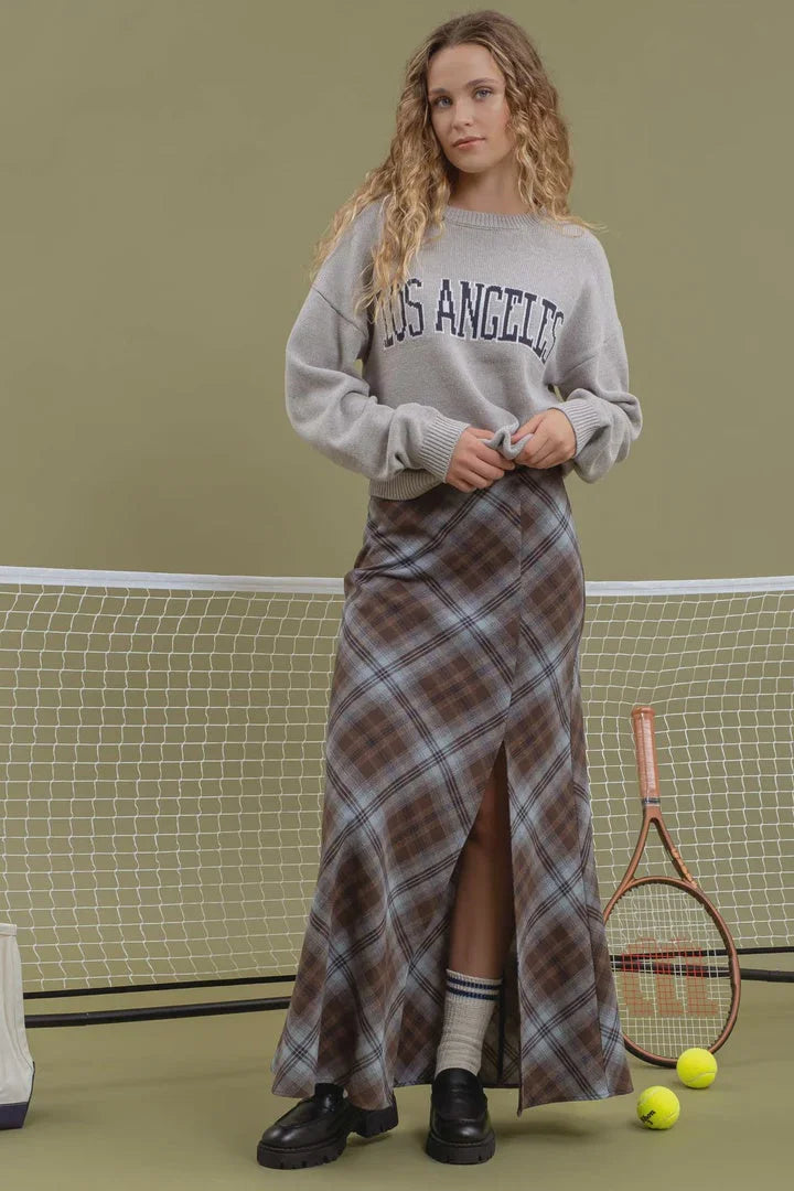 Young woman in a Los Angeles knit crewneck pullover and plaid maxi skirt