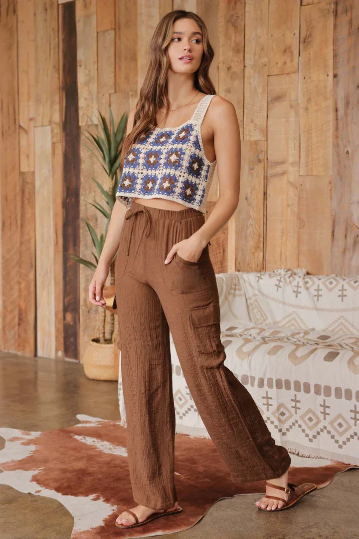 Young woman in patterned crop top and wide leg drawstring cargo pants for casual style