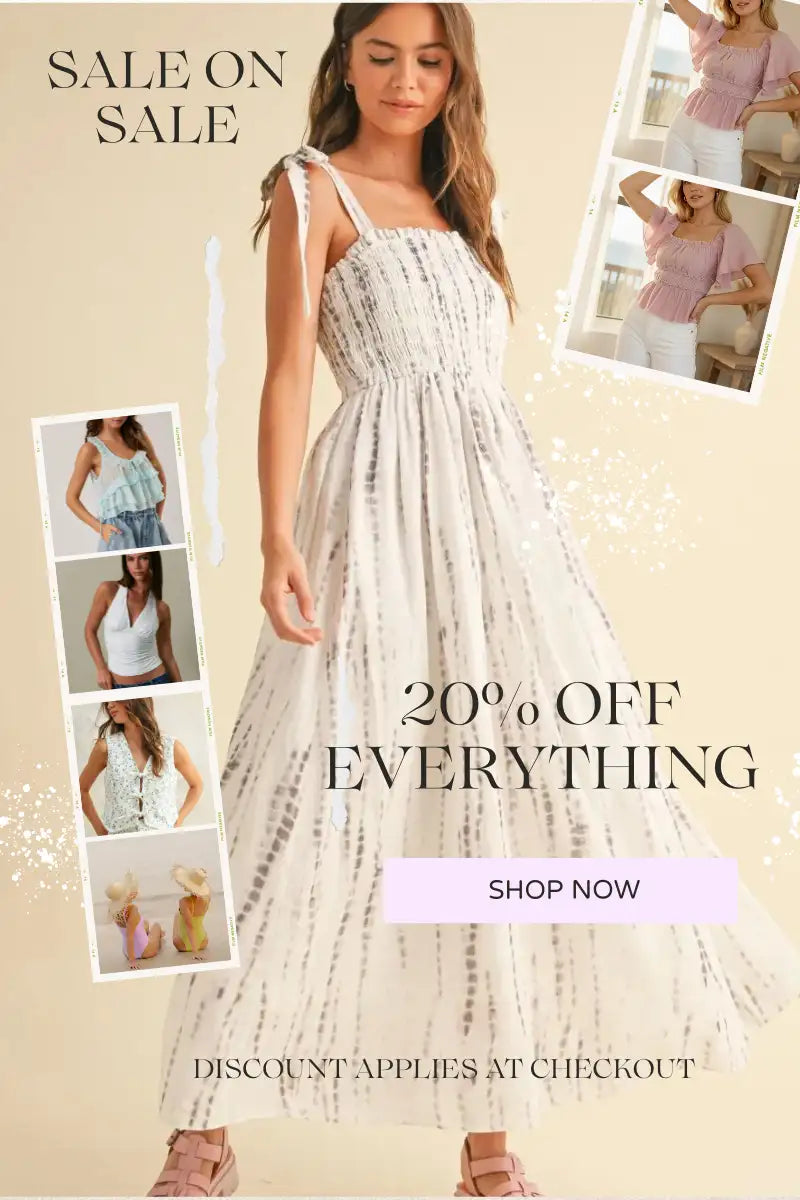 A flowing white and gray tie-dye maxi dress with thin shoulder straps.