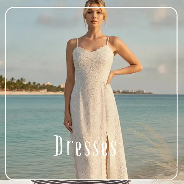 A flowing white lace maxi dress with delicate spaghetti straps and a front slit.