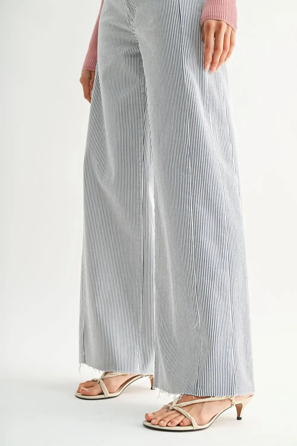 A pair of gray and white vertical stripe wide leg denim jeans crafted from denim fabric for a stylish look.