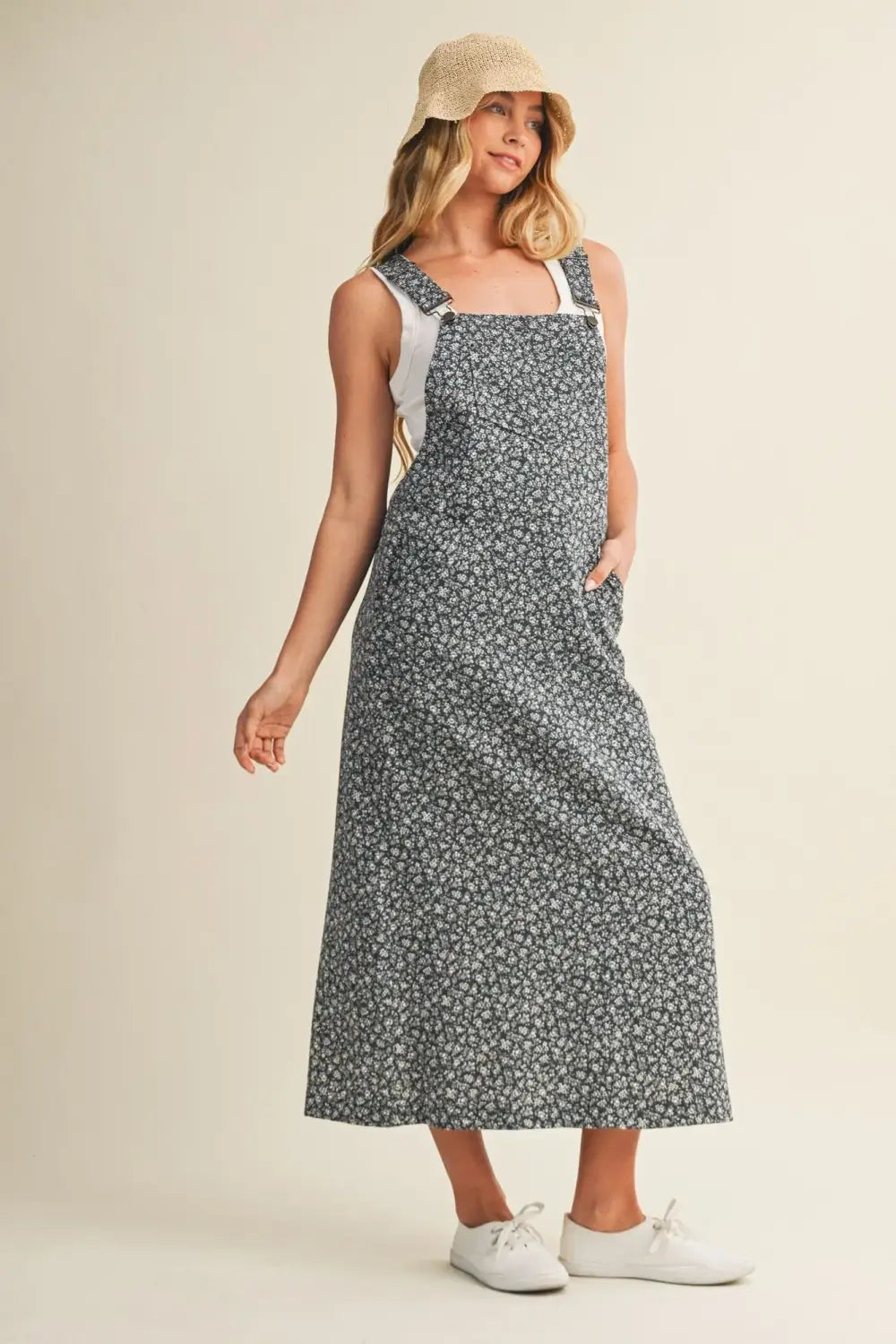 Woman in ditsy floral print dress with adjustable straps and pockets