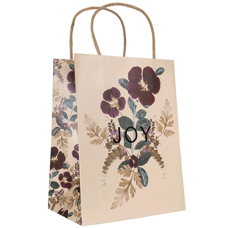 Tan gift bag with a floral scene and the word 