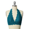 A mannequin wearing a teal, lace, halter top bralette.